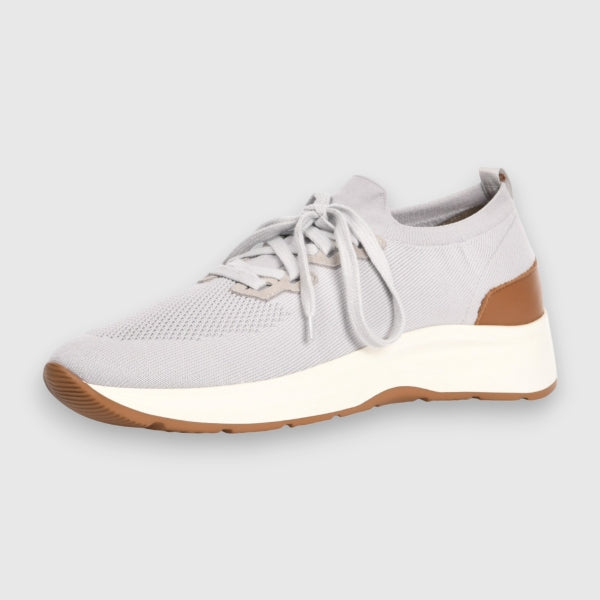 A light grey knit slip-on sneaker with a thick white midsole and brown outsole accents, shown from a side profile on a light grey background. Gran Sasso Sneakers available at Sakks Menswear in Southampton.