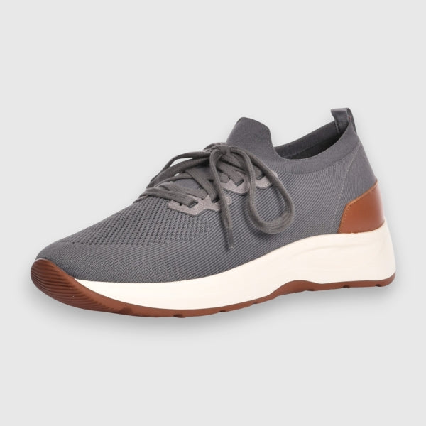 A grey knit slip-on sneaker with a thick white midsole and brown outsole, shown from a side profile on a light grey background. Gran Sasso Sneakers available at Sakks Menswear in Southampton.