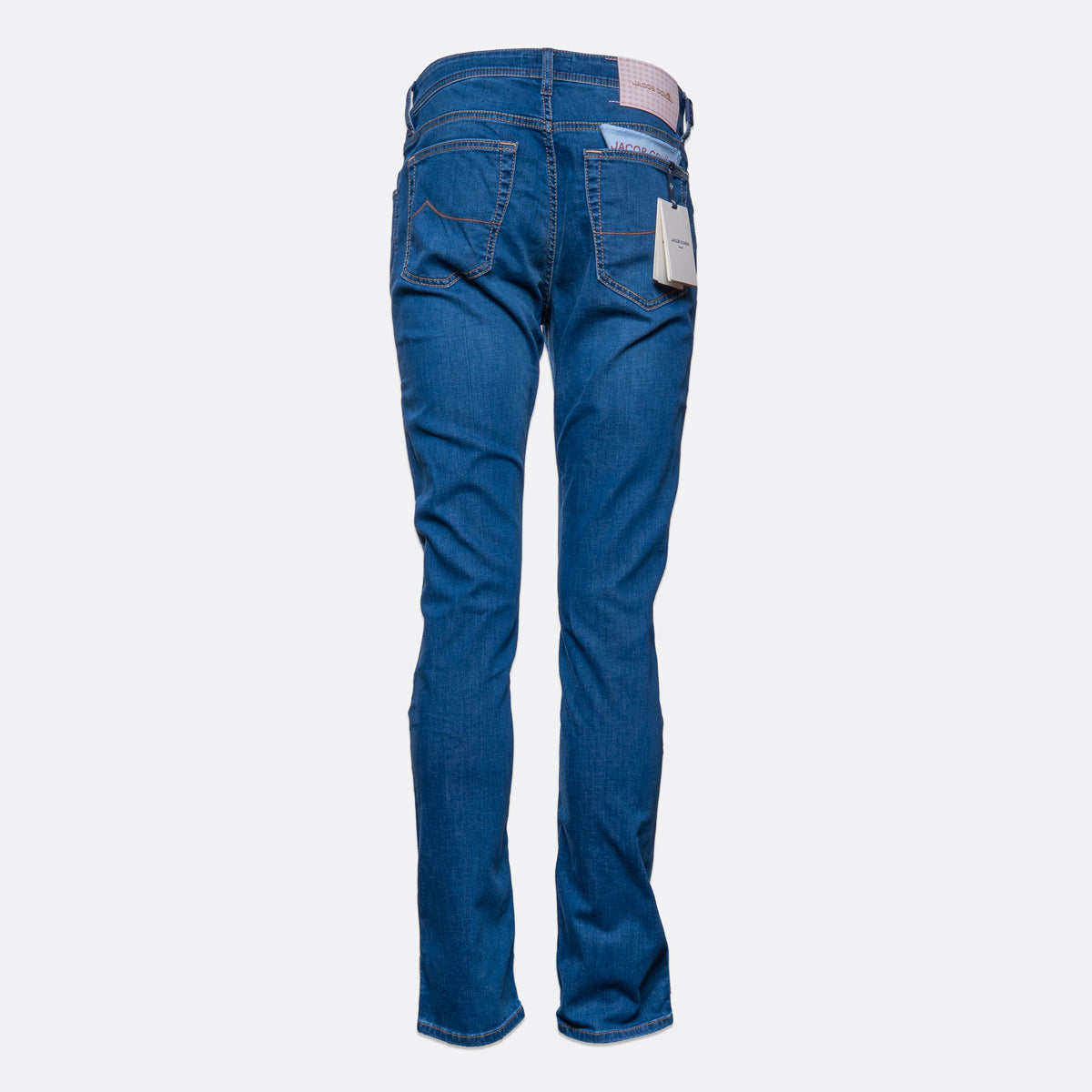 Blue denim jeans shown from the back, featuring a straight-to-flared leg, classic five-pocket design, and a white paper tag attached to the back right pocket, set against a plain light gray background. Jacob Cohën Jeans available at Sakks Menswear in Southampton.