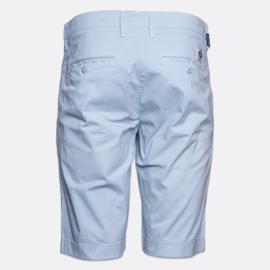 Light blue chino shorts shown from the back, featuring belt loops, two buttoned back pockets, and a small embroidered logo on the right side of the waistband. Jacob Cohën Shorts available at Sakks Menswear in Southampton.