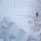 Close-up of the back waistband and pocket area of light blue shorts, showing a buttoned welt pocket, belt loops, and a small embroidered logo patch on the pocket. Jacob Cohën Shorts available at Sakks Menswear in Southampton.