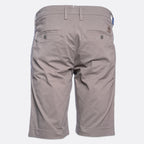 Back view of a pair of men's casual shorts in a light taupe-gray color, featuring belt loops, two buttoned back pockets, and a small brand patch on the upper right side. Jacob Cohën Shorts available at Sakks Menswear in Southampton.