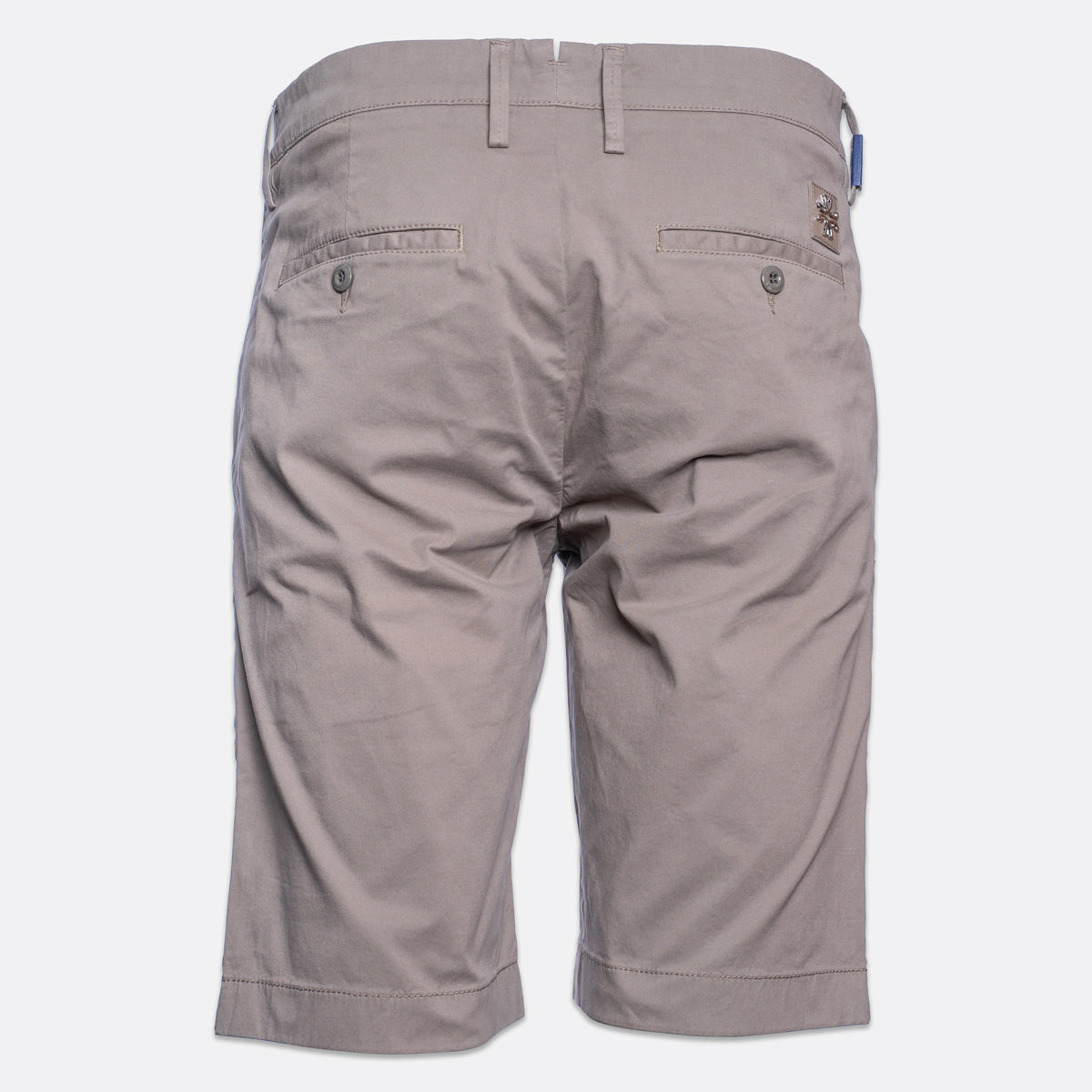 Back view of a pair of men's casual shorts in a light taupe-gray color, featuring belt loops, two buttoned back pockets, and a small brand patch on the upper right side. Jacob Cohën Shorts available at Sakks Menswear in Southampton.