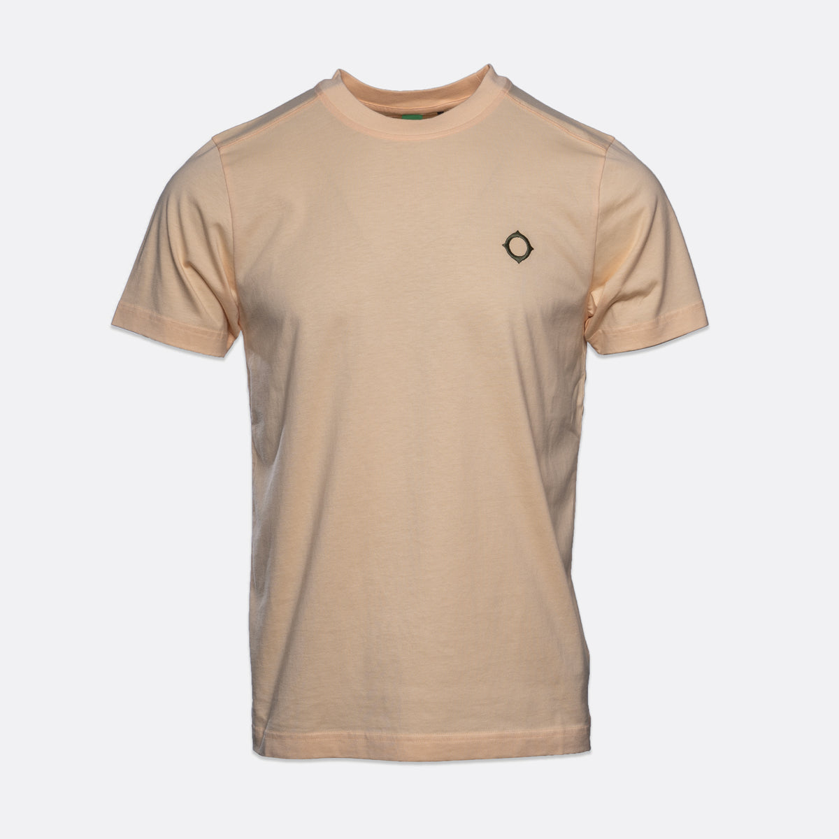 A light beige crewneck t-shirt with a small black geometric diamond logo on the left chest, displayed on a clean light gray background. MA.Strum T-Shirt available at Sakks Menswear in Southampton.