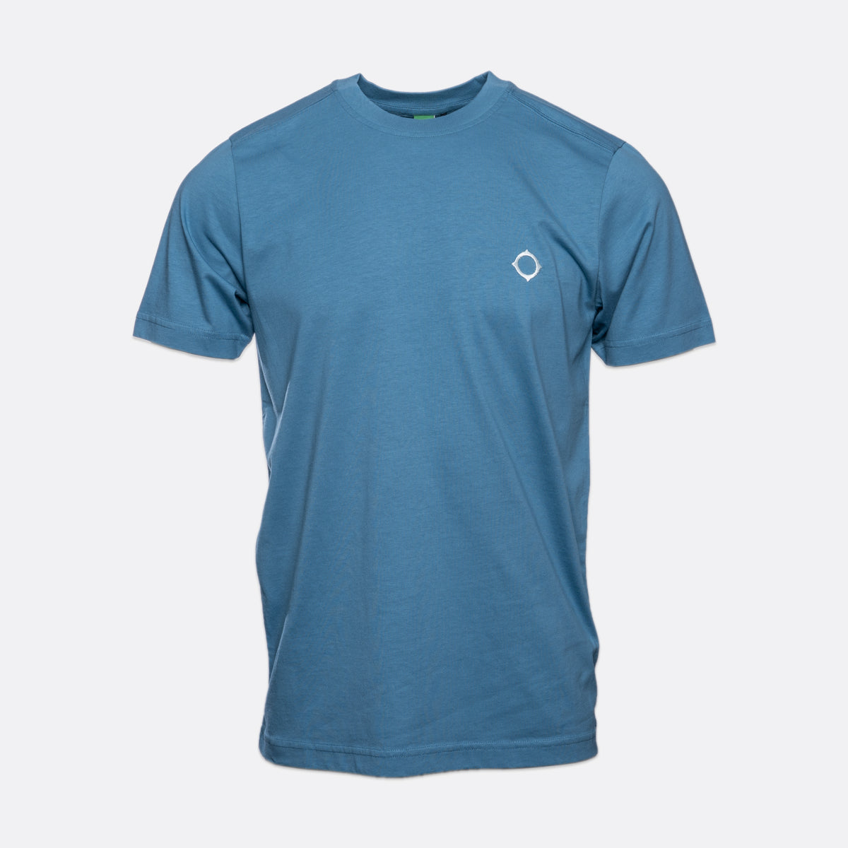 A blue short-sleeve crewneck t-shirt with a small white geometric logo on the left chest, displayed on a light gray background. MA.Strum T-Shirts available at Sakks Menswear in Southampton.
