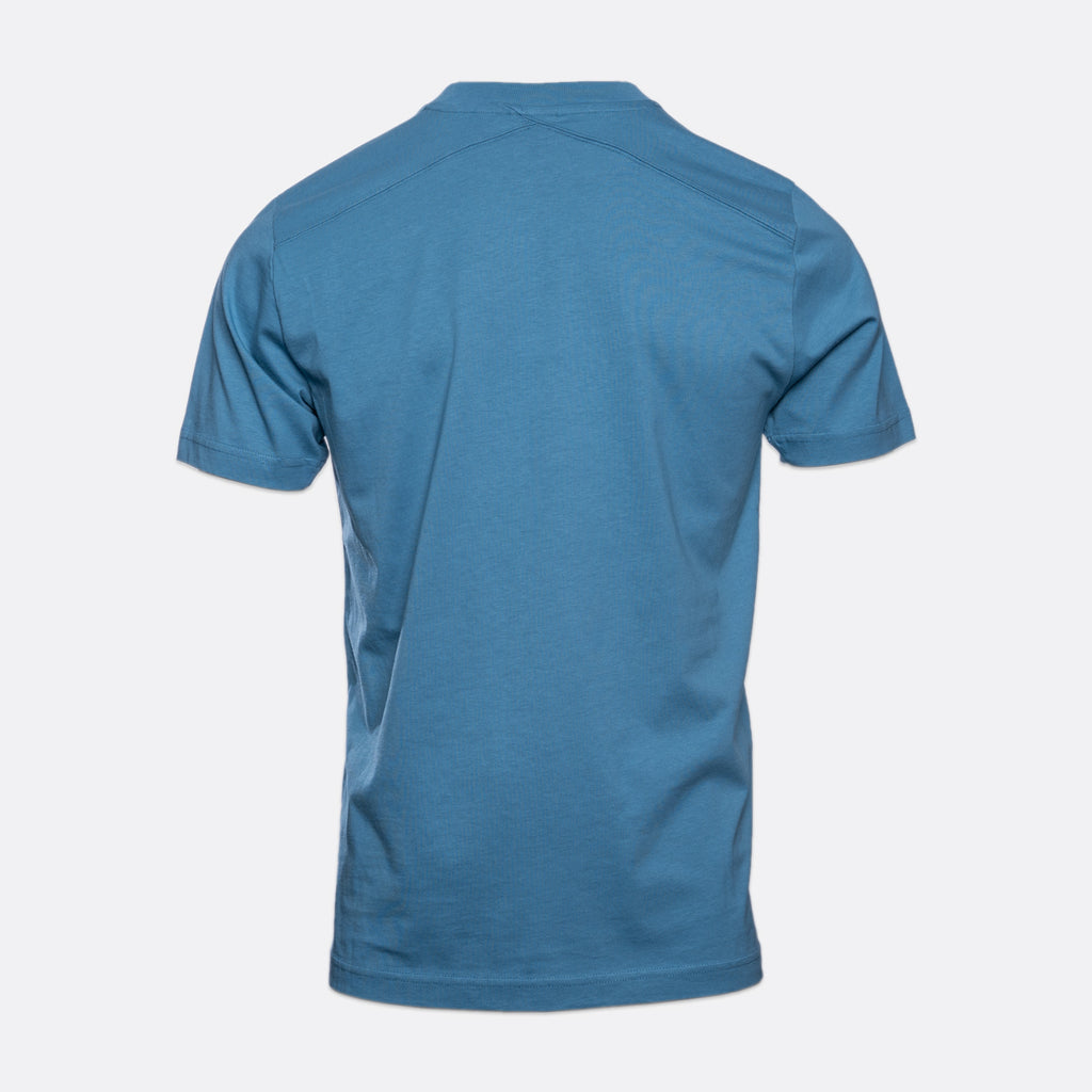 A short-sleeve crewneck t-shirt shown from the back, in a solid medium blue color, displayed on a light gray background. MA.Strum T-Shirts available at Sakks Menswear in Southampton.