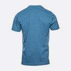 A short-sleeve crewneck t-shirt shown from the back, in a solid medium blue color, displayed on a light gray background. MA.Strum T-Shirts available at Sakks Menswear in Southampton.