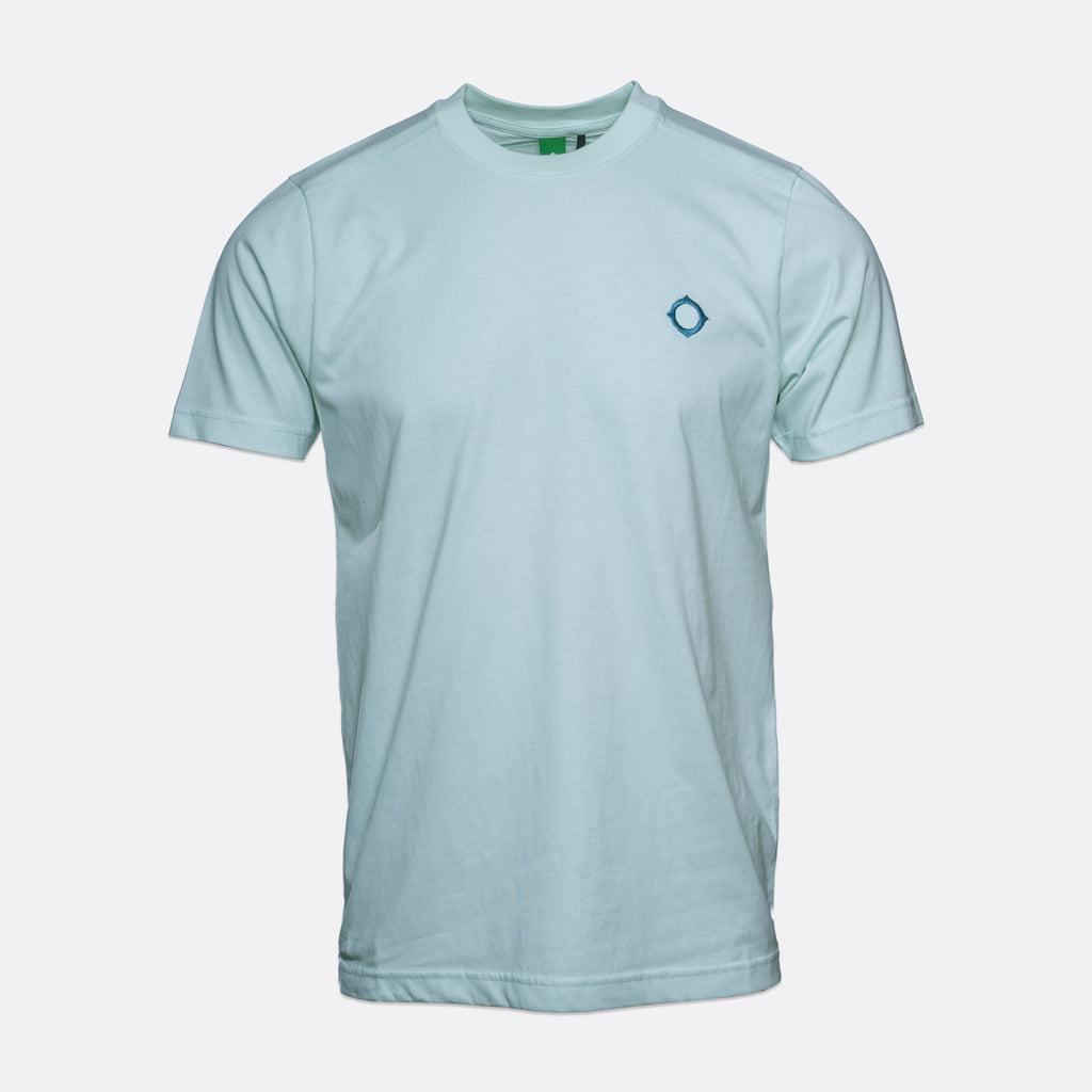 A light blue crewneck t-shirt with a small blue geometric logo on the left chest, displayed on a neutral light gray background. MA.Strum T-Shirt available at Sakks Menswear in Southampton.