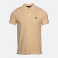 A light beige short-sleeve polo shirt with a three-button placket and a small black diamond logo on the left chest, displayed against a light gray background. MA.Strum Polo available at Sakks Menswear in Southampton.