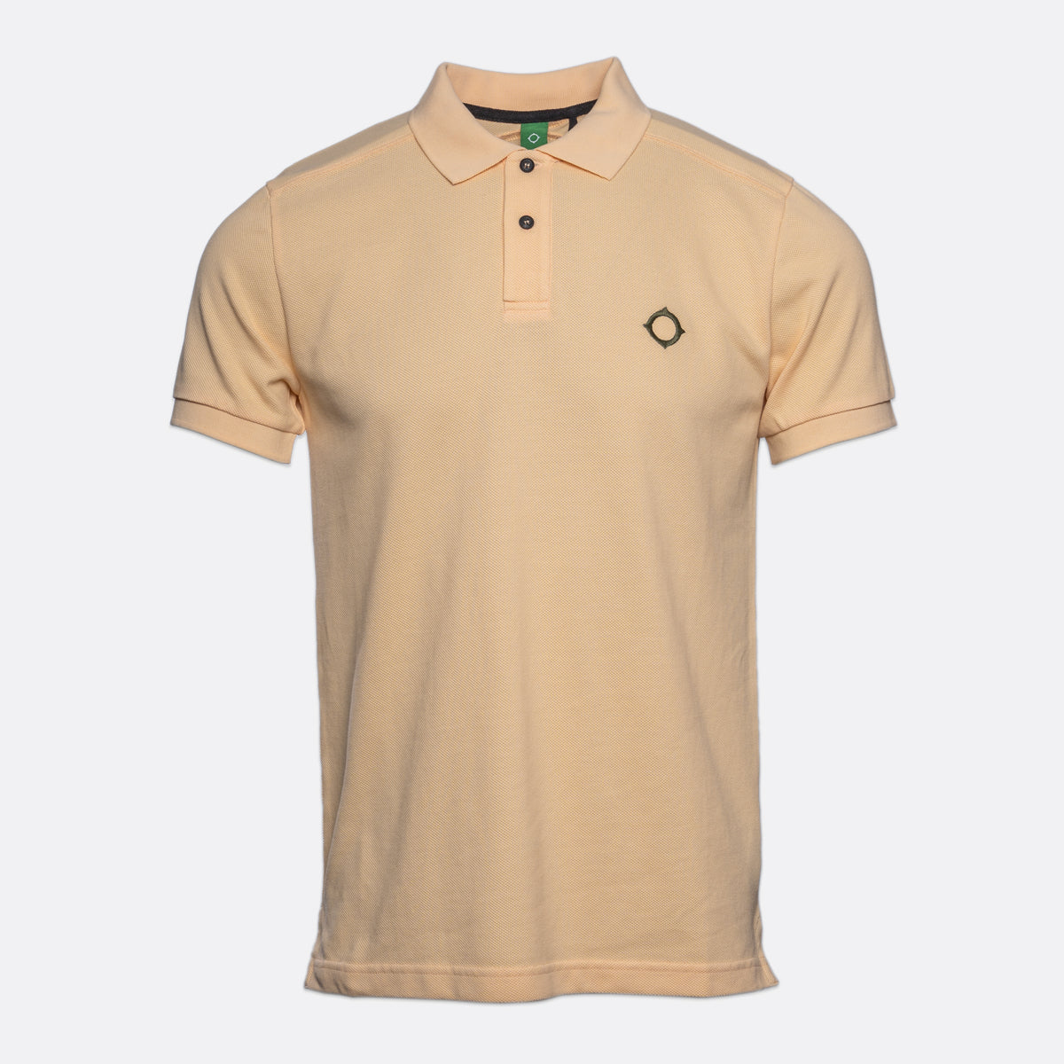 A light beige short-sleeve polo shirt with a three-button placket and a small black diamond logo on the left chest, displayed against a light gray background. MA.Strum Polo available at Sakks Menswear in Southampton.