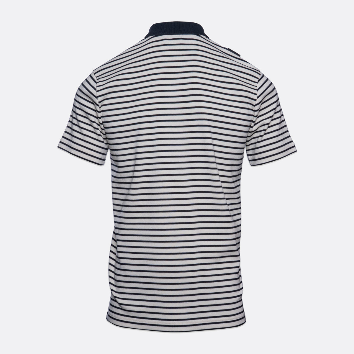 A short-sleeve polo shirt shown from the back, featuring horizontal navy blue and white stripes with a solid navy collar, displayed on a light gray background. MA.Strum Polo available at Sakks Menswear in Southampton.