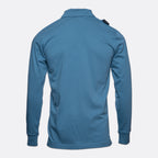 A blue long-sleeve athletic shirt shown from the back, featuring a collar and a small black tag on the upper right shoulder, set against a plain light gray background. MA.Strum Polo available at Sakks Menswear in Southampton.