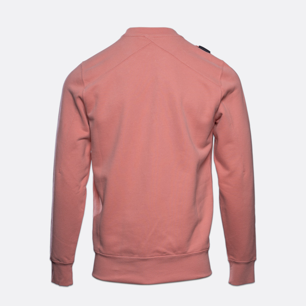 A dusty rose pink long-sleeve crewneck sweatshirt shown from the back, featuring a subtle diagonal seam across the upper back and ribbed cuffs and hem, set against a plain light gray background. MA.Strum Sweatshirt available at Sakks Menswear in Southampton.