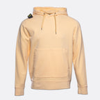 A light peach-colored pullover hoodie with a kangaroo pocket and drawstrings, featuring the Stone Island compass patch on the left shoulder, set against a plain light gray background. MA.Strum Hoodie available at Sakks Menswear in Southampton.