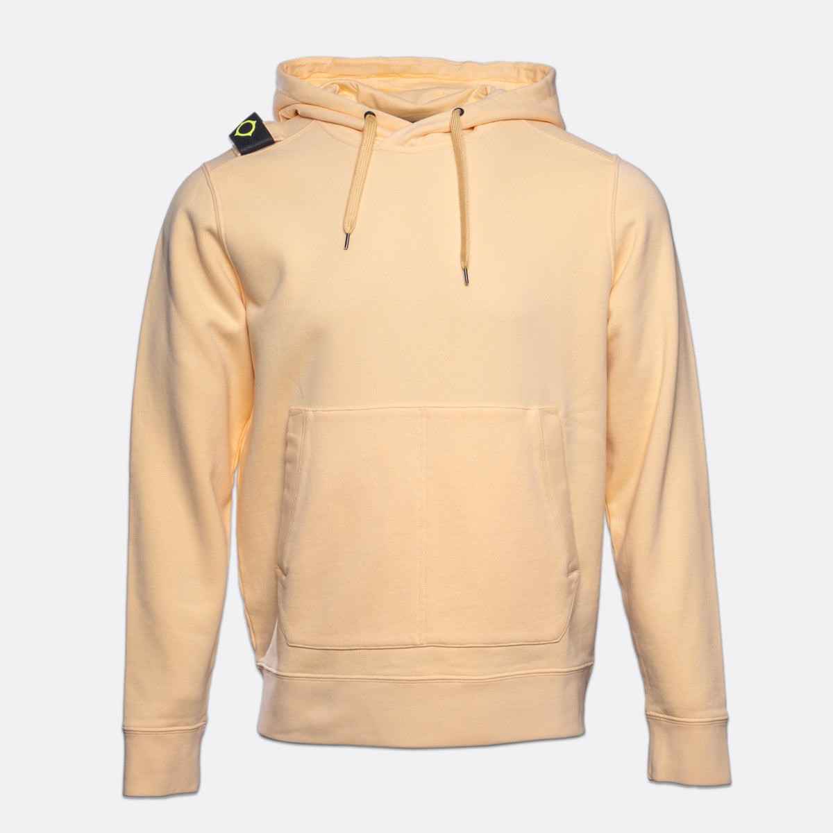 A light peach-colored pullover hoodie with a kangaroo pocket and drawstrings, featuring the Stone Island compass patch on the left shoulder, set against a plain light gray background. MA.Strum Hoodie available at Sakks Menswear in Southampton.