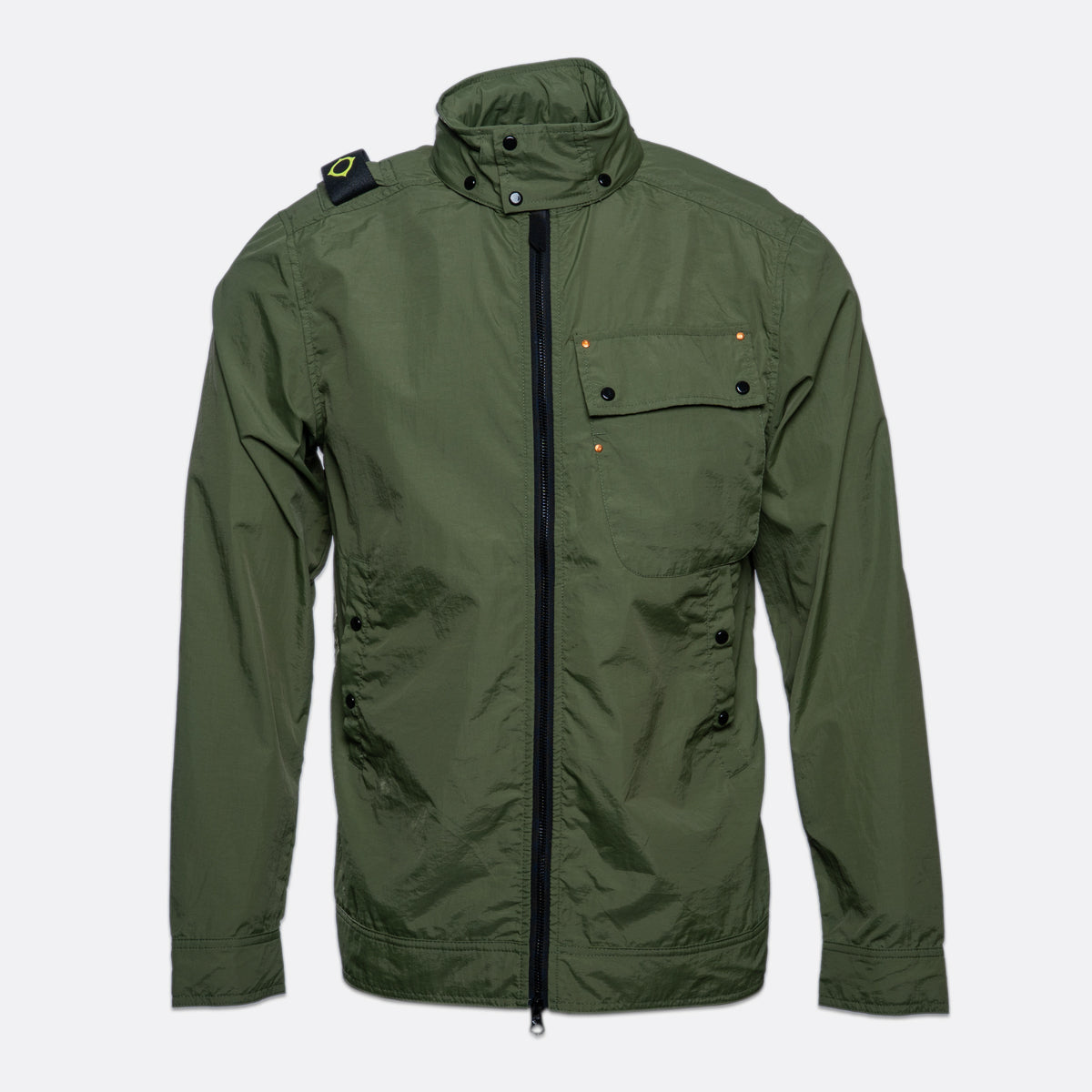 An olive green utility jacket with a high stand-up collar, black front zipper, and flap chest pocket, shown against a light gray background. MA.Strum Jacket available at Sakks Menswear in Southampton.