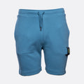 Blue sweat shorts with a drawstring waist and a signature pocket flap on the left leg, shown against a light gray background. MA.Strum Sweat Shorts available at Sakks Menswear in Southampton.