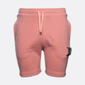 A pair of dusty pink sweat shorts with a matching drawstring waist and a signature Stone Island brand patch on the left leg, shown against a light gray background. MA.Strum Sweat Shorts available at Sakks Menswear in Southampton.