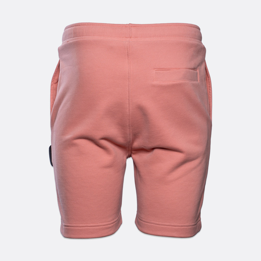 Back view of a pair of dusty pink sweat shorts with a side pocket, shown on a light gray background. MA.Strum Sweat Shorts available at Sakks Menswear in Southampton.