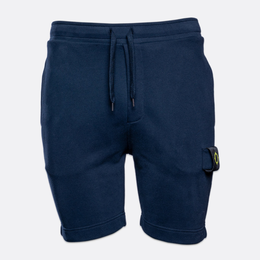 A pair of navy blue sweat shorts with a drawstring waist and a small Stone Island compass logo patch on the lower left leg, shown against a light gray background. MA.Strum Sweat Shorts available at Sakks Menswear in Southampton.
