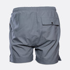 Gray athletic shorts shown from the back, featuring an elastic waistband, a side pocket with a button flap, and a side slit on the right leg, set against a plain light gray background. MA.Strum Swimwear available at Sakks Menswear in Southampton.