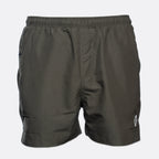 Dark olive green athletic shorts with an elastic waistband and a small white logo on the lower left leg, shown against a light gray background. MA.Strum Swimwear available at Sakks Menswear in Southampton.