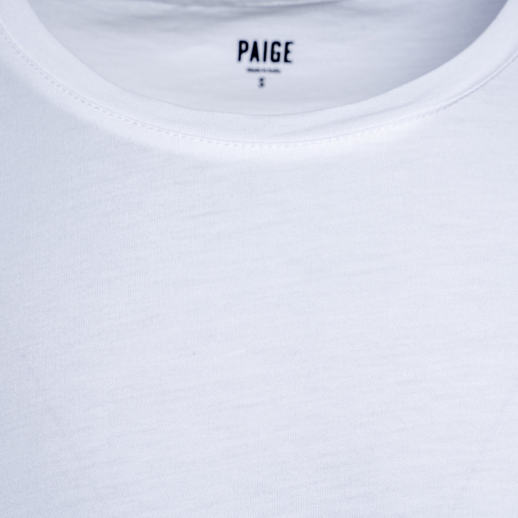 Close-up of a white crew-neck t-shirt showing the inner neck label with the brand name PAIGE. PAIGE T-Shirt available at Sakks Menswear in Southampton.