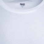 Close-up of a white crew-neck t-shirt showing the inner neck label with the brand name PAIGE. PAIGE T-Shirt available at Sakks Menswear in Southampton.
