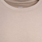 Close-up of a beige crewneck t-shirt with the brand name 'PAIGE' printed inside the collar. PAIGE T-Shirt available at Sakks Menswear in Southampton.