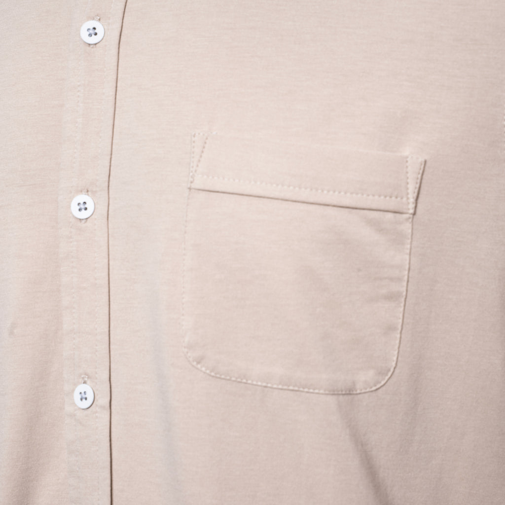 Close-up of a light beige or cream-colored short-sleeve button-up shirt with a chest pocket and white  PAIGE Shirt available at Sakks Menswear in Southampton.buttons.