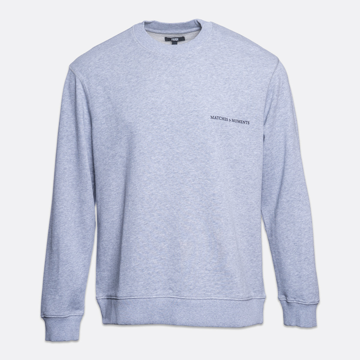 A light heather gray crewneck sweatshirt with 'MATCHES & MOMENTS' printed in black on the left chest, displayed on a clean white background. PAIGE Sweatshirt available at Sakks Menswear in Southampton.