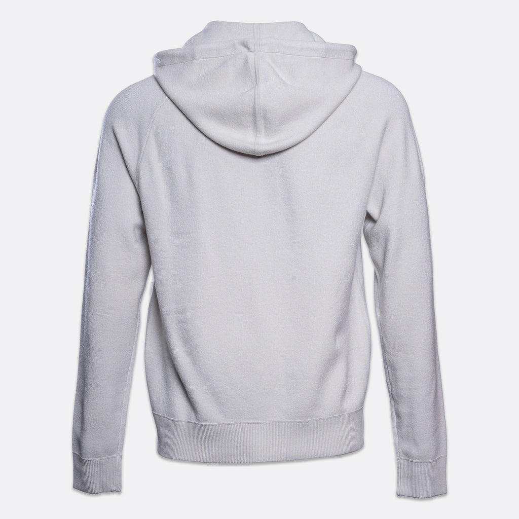 A light gray pullover hoodie shown from the back, featuring a classic hood, long sleeves, and ribbed cuffs and hem, displayed on a clean light gray background. PAIGE Hoodie available at Sakks Menswear in Southampton.