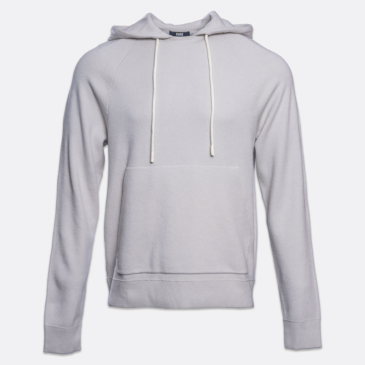 A light gray pullover hoodie with white drawstrings and a front kangaroo pocket, shown on a plain light gray background. PAIGE Hoodie available at Sakks Menswear in Southampton.