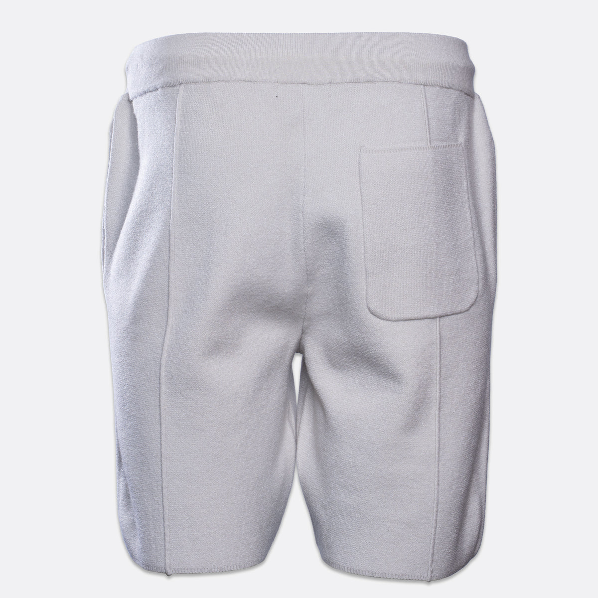 The back view of light gray sweat shorts, featuring a wide elastic waistband and a single patch pocket on the left side, shown against a plain light gray background. PAIGE Sweat Shorts available at Sakks Menswear n Southampton.