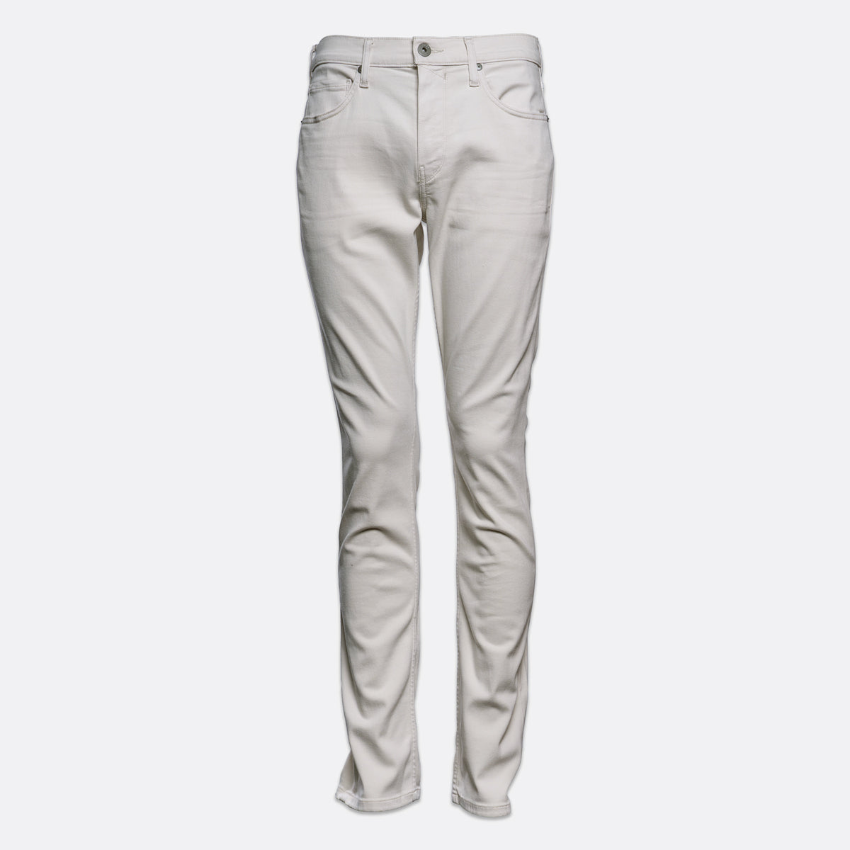 A pair of slim-fit jeans in a light beige or off-white denim wash, shown from the front against a plain light gray background. PAIGE Jeans available at Sakks Menswear in Southampton.