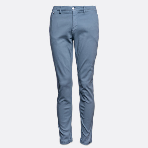 A pair of slim-fit blue chinos with a straight waistband and a single white button, shown against a plain light gray background. Replay Chinos available at Sakks Menswear in Southampton.