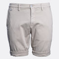A pair of light beige chino shorts with a button closure and rolled cuffs, shown against a plain light gray background. Replay Shorts available at Sakks Menswear in Southampton.