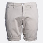 A pair of light beige chino shorts with a button closure and rolled cuffs, shown against a plain light gray background. Replay Shorts available at Sakks Menswear in Southampton.