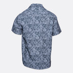 Short-sleeve button-up camp shirt with an all-over blue and gray tropical palm leaf pattern, shown from the back on a light gray background. Sand Copenhagen Short Sleeve Shirt available at Sakks Menswear in Southampton.