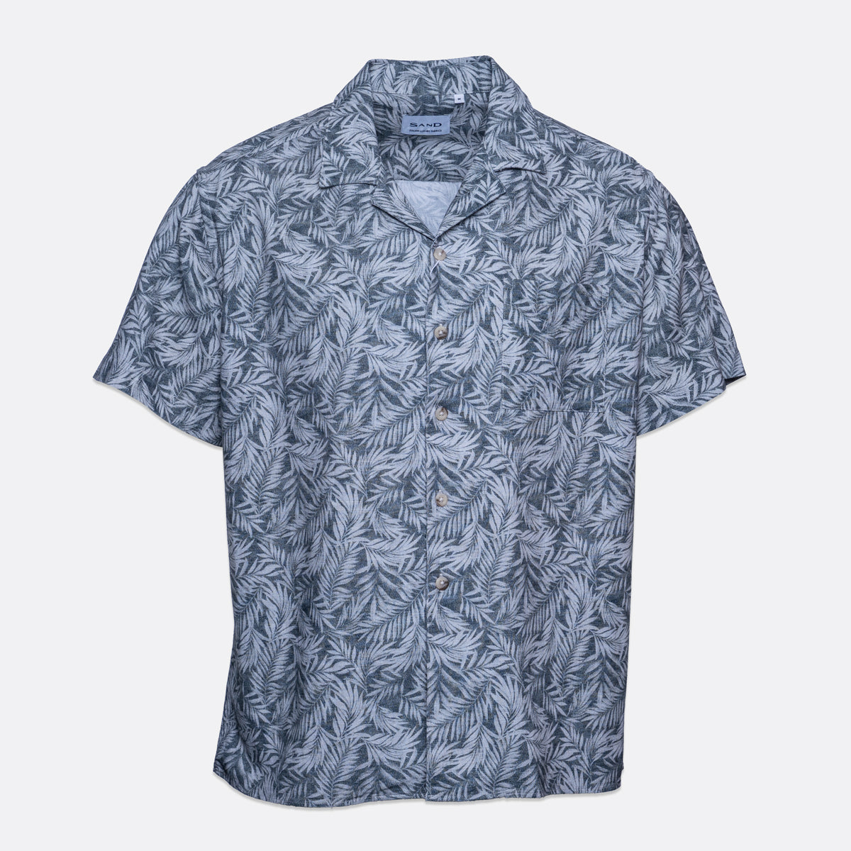 A short-sleeve button-up camp shirt with a blue and gray palm leaf pattern, displayed flat against a light gray background. Sand Copenhagen Short Sleeve Shirt available at Sakks Menswear in Southampton.