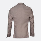 A men's blazer shown from the back, featuring a slim-fit silhouette, long sleeves, and a subtle textured weave in a taupe-brown color, set against a plain light gray background. Sand Copenhagen Blazers available at Sakks Menswear in Southampton.