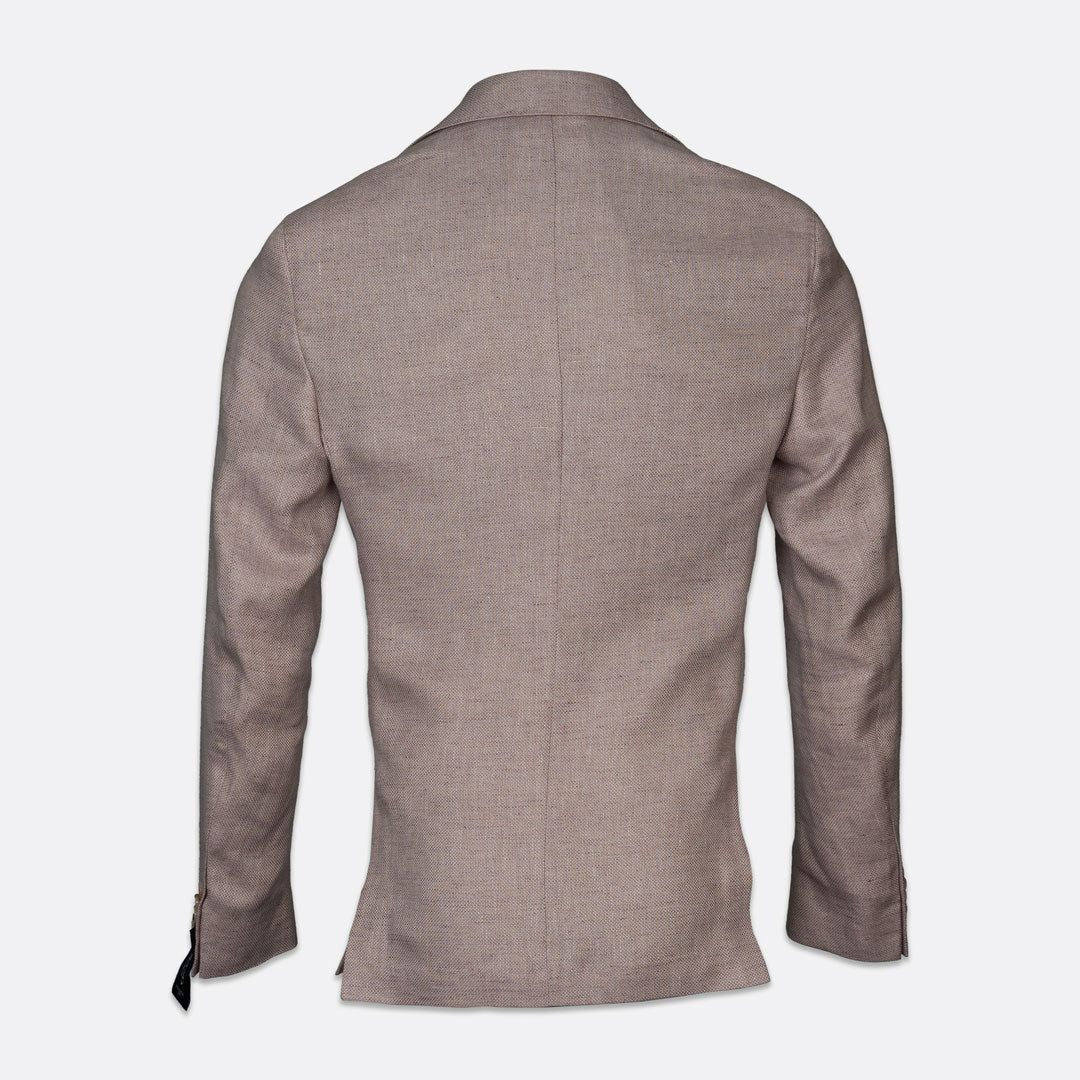 A men's blazer shown from the back, featuring a slim-fit silhouette, long sleeves, and a subtle textured weave in a taupe-brown color, set against a plain light gray background. Sand Copenhagen Blazers available at Sakks Menswear in Southampton.