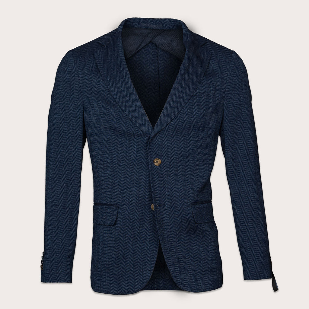 A dark navy blue textured blazer with a single gold button, displayed on a light beige background. Sand Copenhagen Blazers available at Sakks Menswear in Southampton.