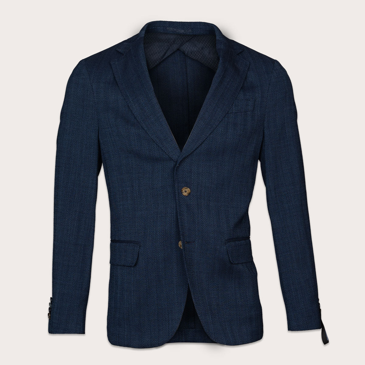 A dark navy blue textured blazer with a single gold button, displayed on a light beige background. Sand Copenhagen Blazers available at Sakks Menswear in Southampton.