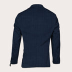 The back view of a men's dark navy blue textured blazer, displayed on a clean, solid off-white background. Sand Copenhagen Blazers available at Sakks Menswear in Southampton.