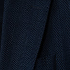 Close-up of a dark navy blue textured fabric with a fine woven herringbone pattern. Sand Copenhagen Blazers available at Sakks Menswear in Southampton.