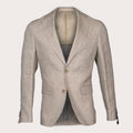 A light beige textured linen blazer with notched lapels and two brown buttons, displayed on a mannequin against a light cream background. Sand Copenhagen Blazer available at Sakks Menswear in Southampton.