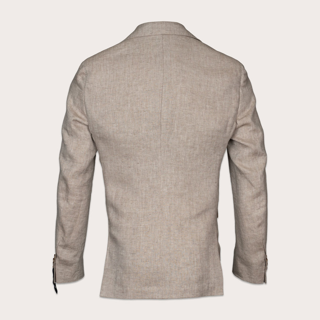 A light beige textured blazer shown from the back, featuring a clean collar, long sleeves, and subtle button details on the cuffs, set against a solid off-white background. Sand Copenhagen Blazer available at Sakks Menswear in Southampton.