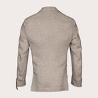 A light beige textured blazer shown from the back, featuring a clean collar, long sleeves, and subtle button details on the cuffs, set against a solid off-white background. Sand Copenhagen Blazer available at Sakks Menswear in Southampton.