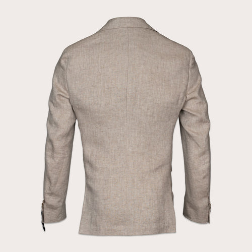 A light beige textured blazer shown from the back, featuring a clean collar, long sleeves, and subtle button details on the cuffs, set against a solid off-white background. Sand Copenhagen Blazer available at Sakks Menswear in Southampton.